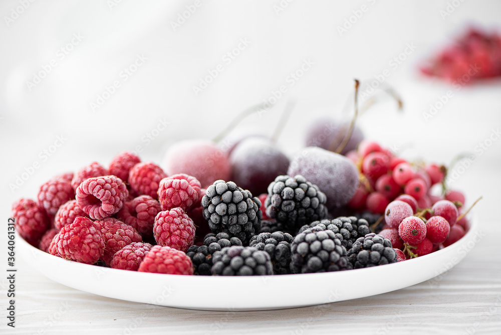 assorted frozen berries on a white plate assorted frozen berries on a white plate