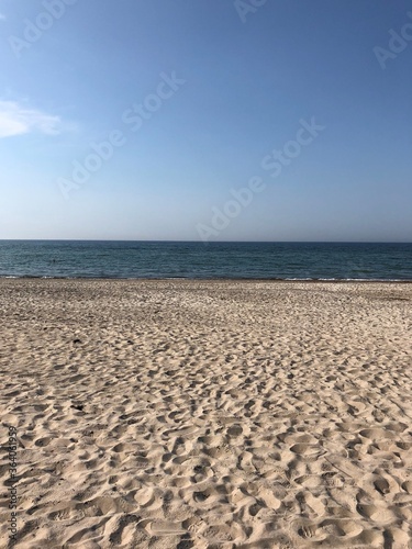 Sunny beach with blue sky