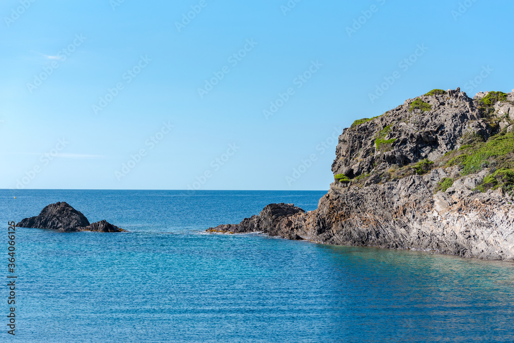 Sea landscape with Cap de Creus, natural park. Eastern point of Spain, Girona province, Catalonia. Famous tourist destination in Costa Brava. Sunny summer day with blue sky and clouds