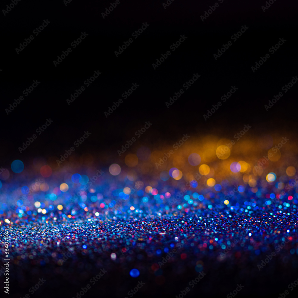 Obraz premium Multicolored shining glitter in focus and out of focus, abstract shiny background