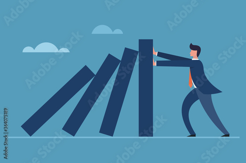 Business executive blocking the falling of vertical blocks