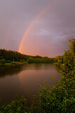 Beautiful evening sunset landscape with lake and rainbow, spring and forest in Vereshchytsia, Lviv district. june 2020.