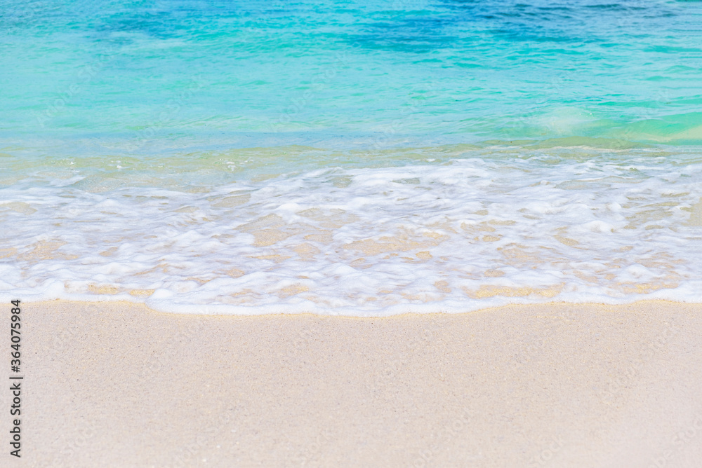 Wave of blue ocean on sandy white beach. texture Background.