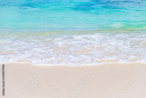 Wave of blue ocean on sandy white beach. texture Background.