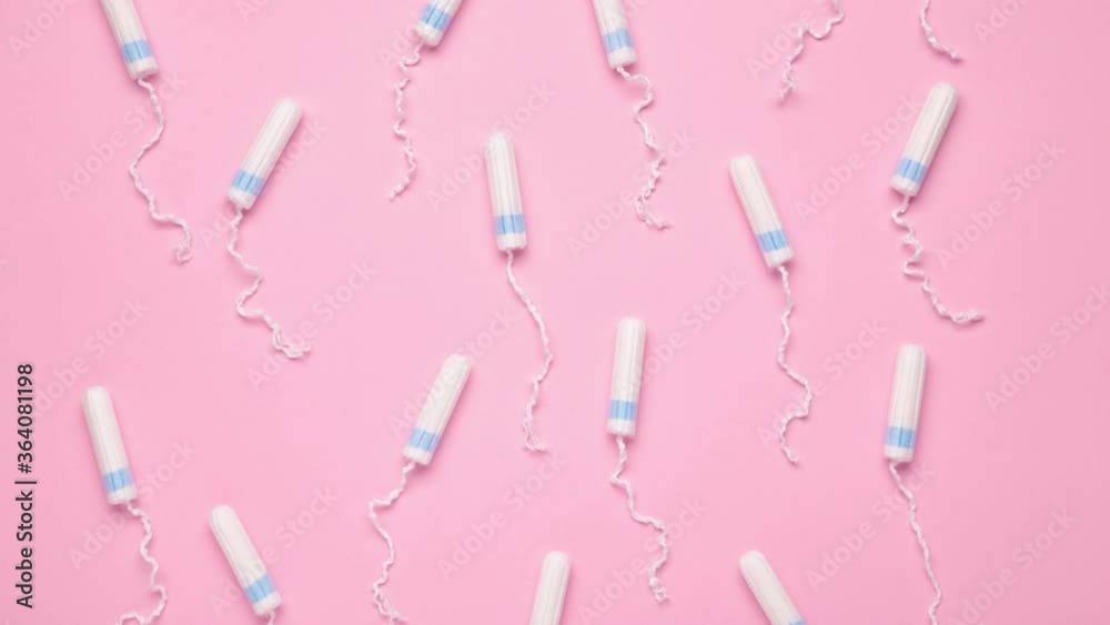 Menstrual tampons move on a pink background. Cotton tampon for women. Top view. Stop motion