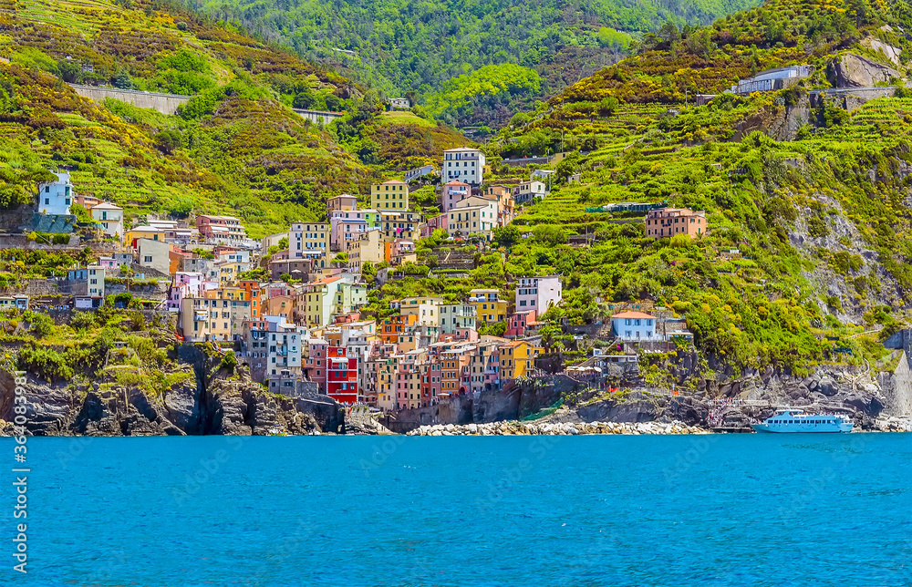 A view from the sea towards the village of Riomaggiore, Italy in the summertime