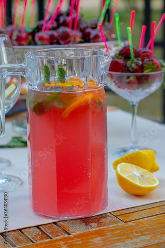 raspberry mojito drink in jar, cherry blurred background
