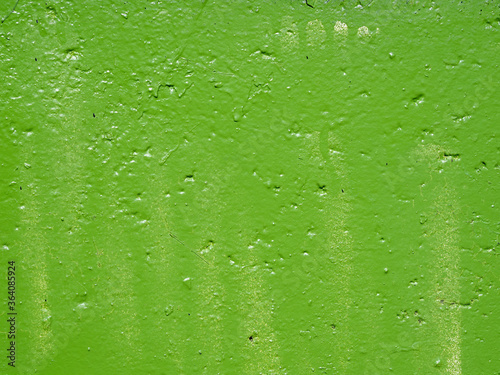 Old wall painted by green paint. Background and texture