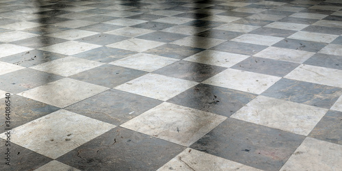 Old ceramic tile floor and blurry reflections in it photo