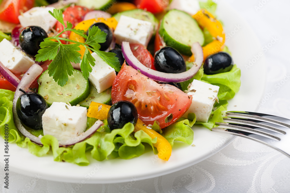 Greek salad on the white plate Greek salad on the white plate