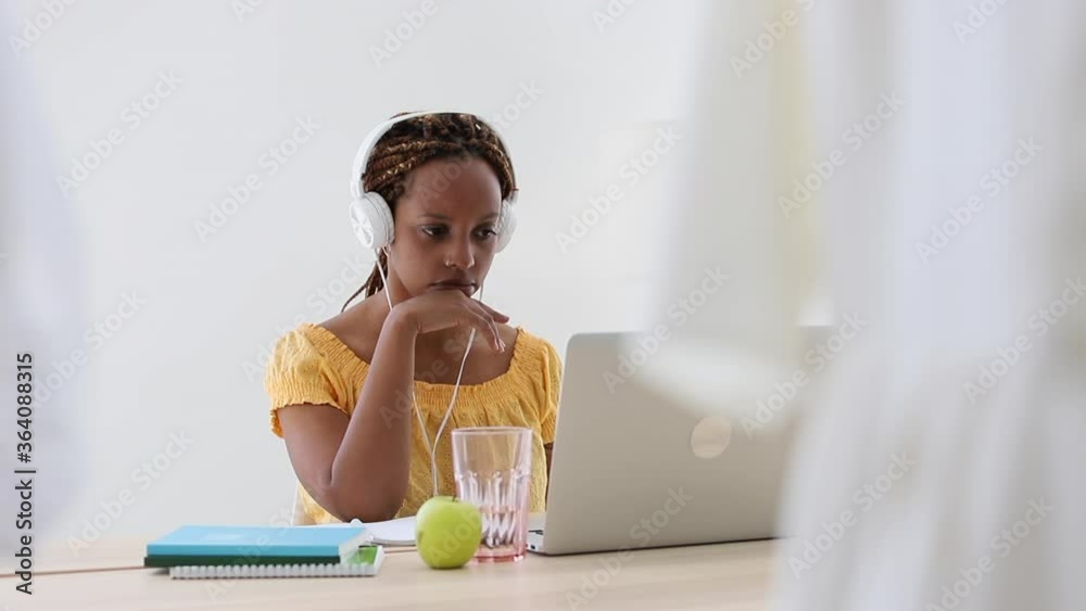 woman wear headphones watching training university lecture and shaking her head Spbi. refusing confused afro girl studying online with notebook, laptop and video conference lesson call. woman wear headphones watching training university lecture and shaking her head Spbi. refusing confused afro girl studying online with notebook, laptop and video conference lesson call.