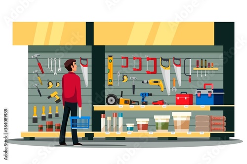 Man choosing at tools stand in constructor shop
