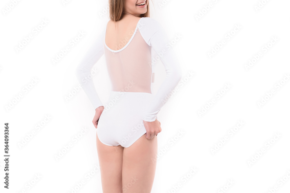 Girl in white gymnastic leotard looks over. Gymnastic girl. young woman in sportswear on white background Girl in white gymnastic leotard looks over. Gymnastic girl. young woman in sportswear on white background