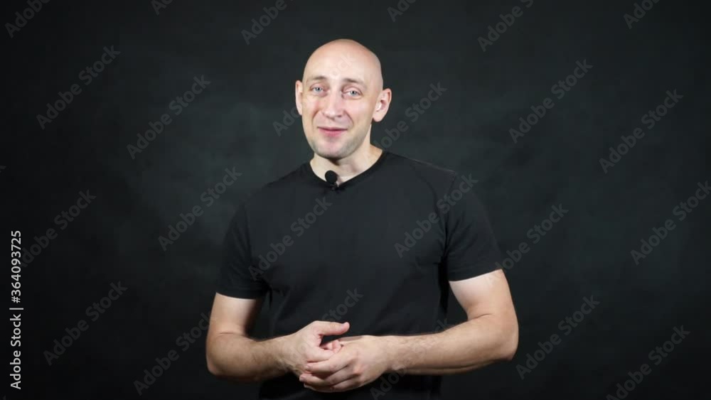 A bald European man in a black T-shirt. A bald European man in a black T-shirt.