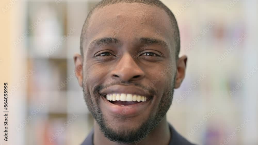 Close up of Smiling Young African Man Looking at the Camera Close up of Smiling Young African Man Looking at the Camera