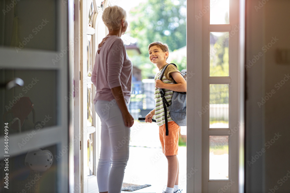 Mother and son with backpack in entrance hall
Mother and son with backpack in entrance hall