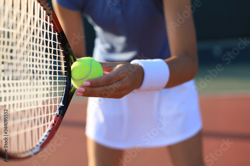 Close up of a tennis player hitting the ball with racket. © ty