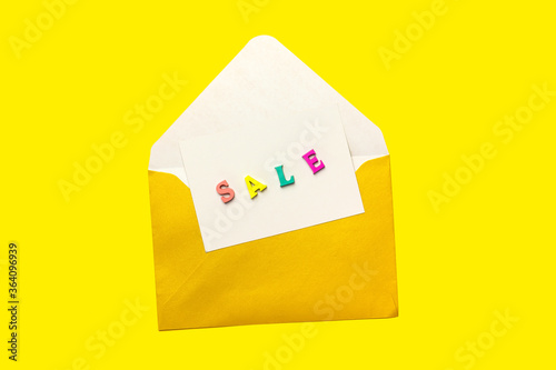 sale note in an open envelope isolated on yellow background