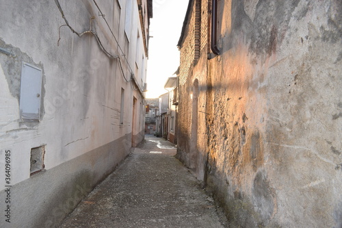 Narrow alley in Oppido Mamertina, Calabria, Italy, with early morning light photo