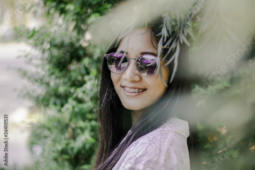 Close up the face of girl with green leaves background, Hipster style of asian girl with green leaves bush