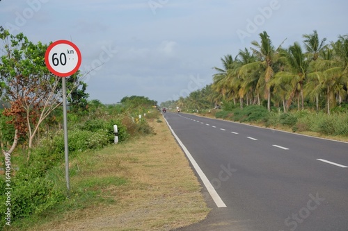 Signs of attention for vehicle drivers to limit their speed to 60 km/hour on a straight road