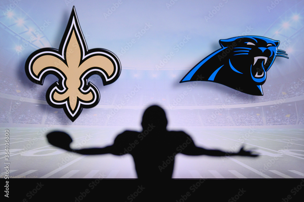 New Orleans Saints vs. Carolina Panther. NFL Game. American Football League  match. Silhouette of professional player celebrate touch down. Screen in  background. Stock Photo