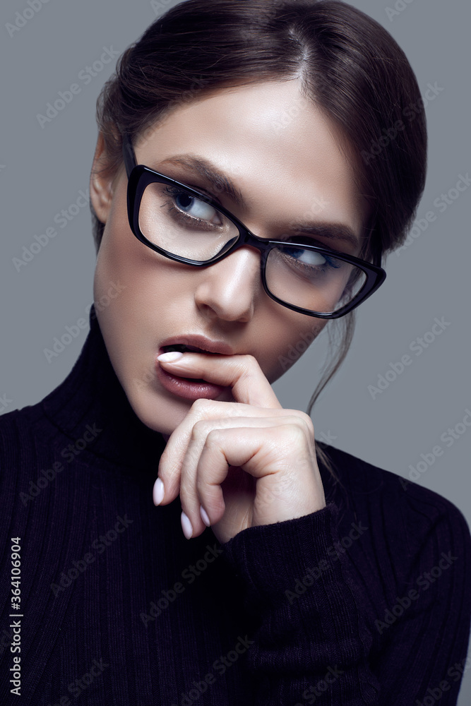 Cute student girl wearing black turtleneck sweater and stylish eyeglasses Cute student girl wearing black turtleneck sweater and stylish eyeglasses