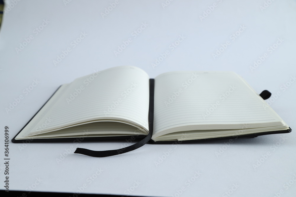 Business concept - sliver laptop with Top view collection of black fly black notebook front, back and white open page, Business concept - sliver laptop with Top view collection of black fly black notebook front, back and white open page,