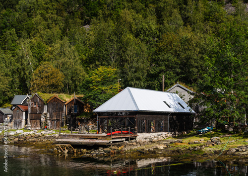 Old wooden buildings by the waters at Geiranger Norway