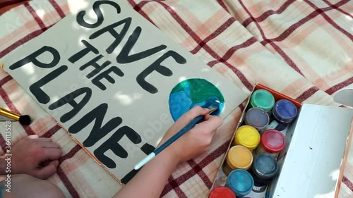 young kids drawing Save the planet Poster in summer camp. volunteer child painting earth banner. school activity against global warming, pollution, recycle garbage. ecology environment problem