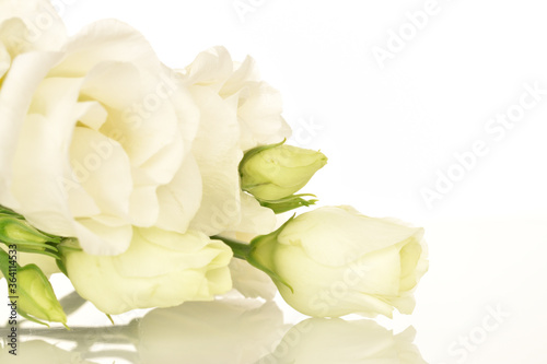 Slate serving board with water drops  close-up. Bouquet of white eustoma  close-up.