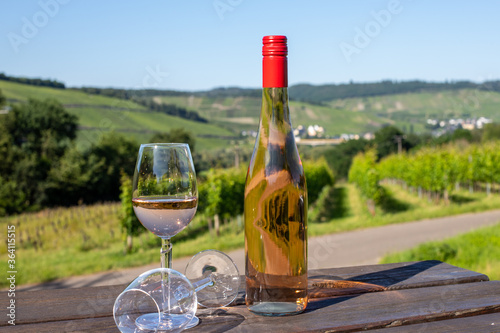 Wine bottle with glasses on wooden table photo