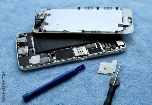 Person Repairing Smartphone with A Screwdriver photo