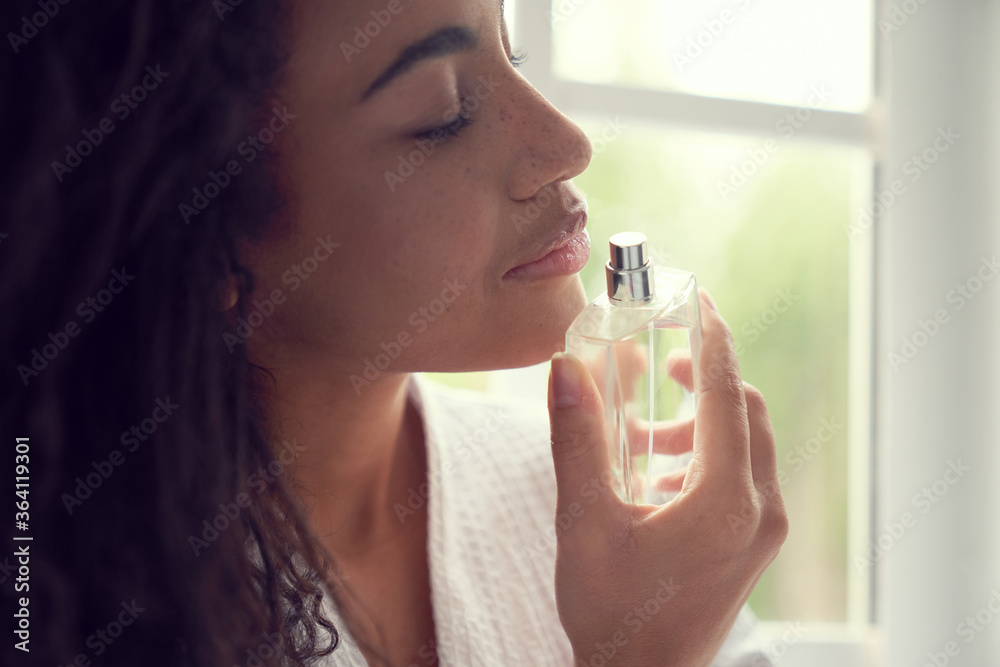 Fototapeta premium Calm pretty lady using fragrance at home