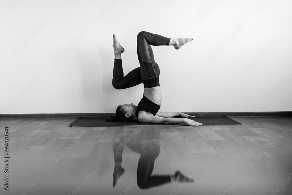 Fitness slim young girl with ponytail and in sports uniform doing gymnastics formwork exercises indoors at home. Fitness slim young girl with ponytail and in sports uniform doing gymnastics formwork exercises indoors at home.