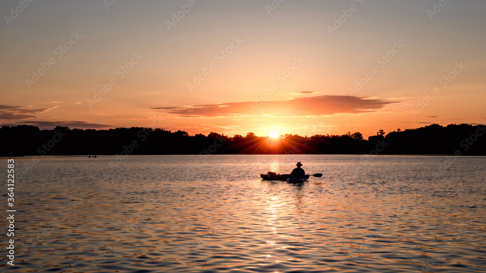 People are boating and having fun under sunset	