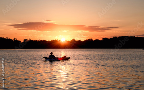 People are boating and having fun under sunset 