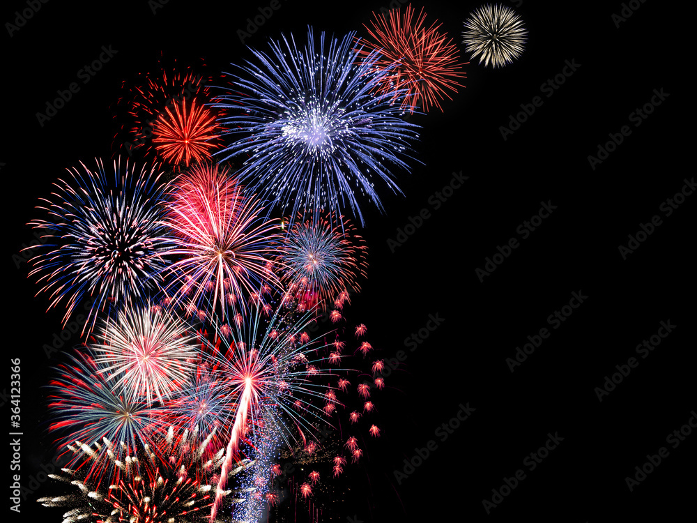 Red and blue fireworks display fills the sky during night time celebration Red and blue fireworks display fills the sky during night time celebration