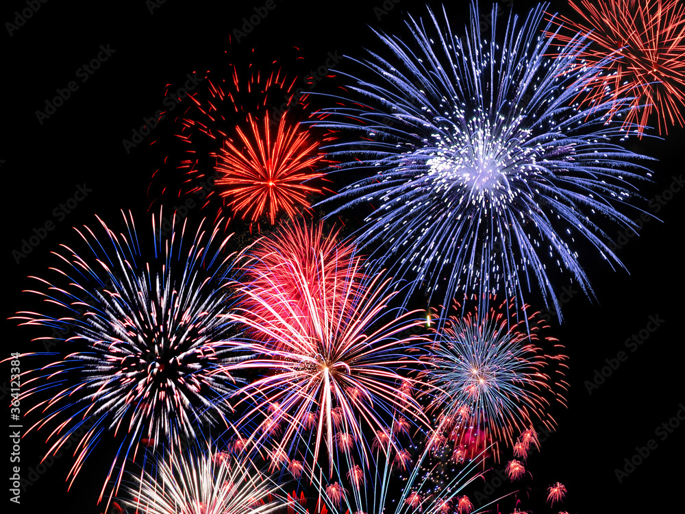 Explosive red and blue fireworks display fills the night sky Explosive red and blue fireworks display fills the night sky