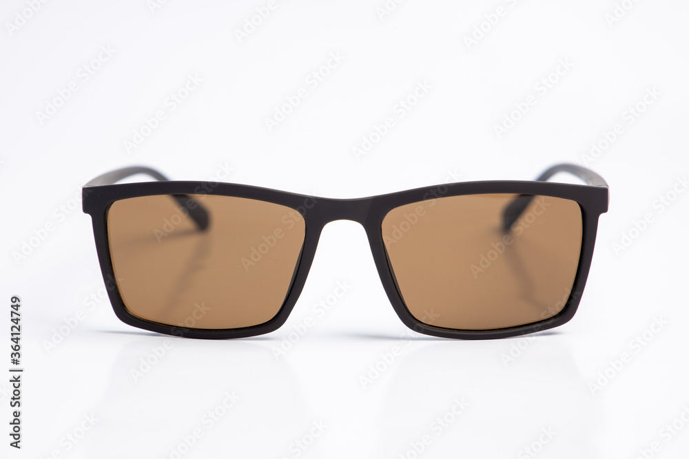 Sunglasses with brown lenses on white isolated background. female or male , fashion Sunglasses with brown lenses on white isolated background. female or male , fashion