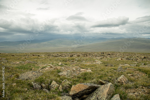 Amazing view of Altai mountain. Background of a steppe at the plateau Ukok. Russian adventures. Mountain hiking in the Altai republic. Active holiday with family and friends. Image with noise effect.