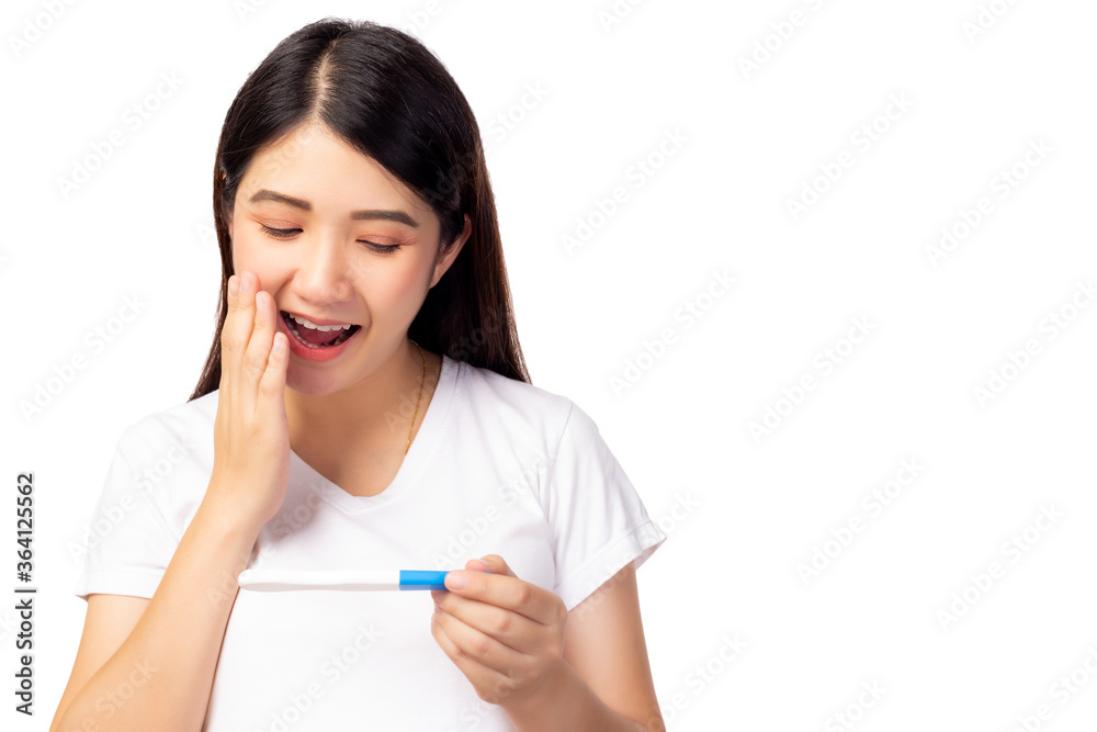 Happy pregnant woman holding pregnancy test and get surprise because single mother has baby with smiley face. Young Mother waiting newborn baby prenatal, pregnancy, motherhood, expecting concept Happy pregnant woman holding pregnancy test and get surprise because single mother has baby with smiley face. Young Mother waiting newborn baby prenatal, pregnancy, motherhood, expecting concept