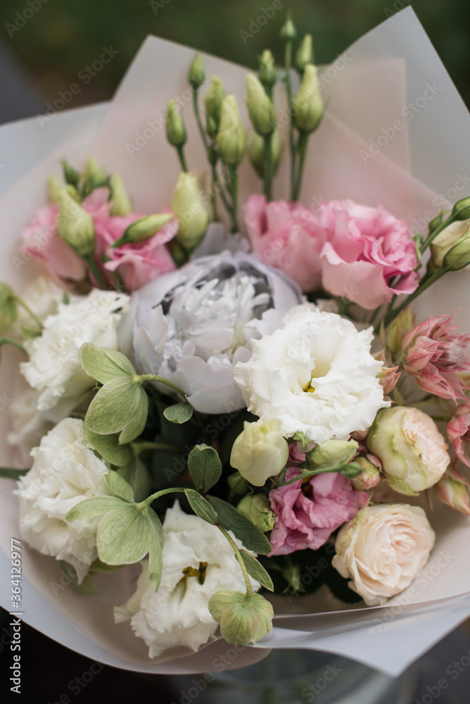 Perfect bouquet of flowers on black table near trees Perfect bouquet of flowers on black table near trees