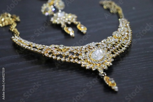 Indian style gold imitation jewelry that is necklace with stoles and long earrings
