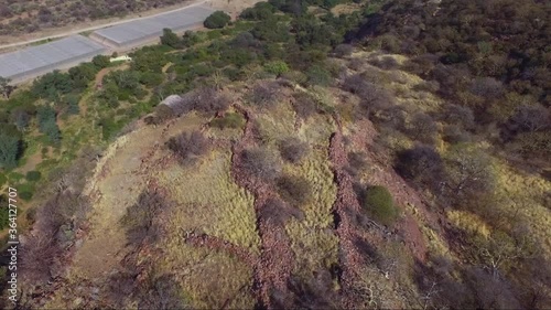ancient ruins on an African Mapungubwe site mountain with stone walls dry grass and trees added grain noise out of focus