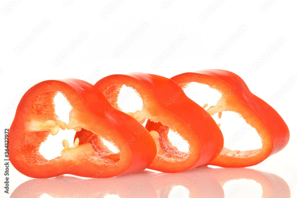 Red organic bell peppers, close-up, on a white background. Red organic bell peppers, close-up, on a white background.