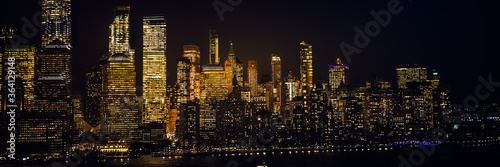 Amazing panorama view on New York City skyline and Downtown Manhattan from Jersey City during night. Banner image