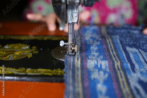 Close up woman hands sewing Traditional prayer mat with old sewing machine
