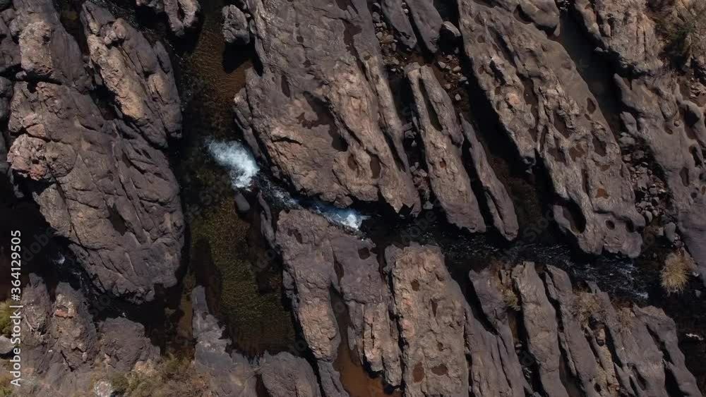 arial view of a mountain spring river clear water and rocks moving added noise grain and out of focus arial view of a mountain spring river clear water and rocks moving added noise grain and out of focus