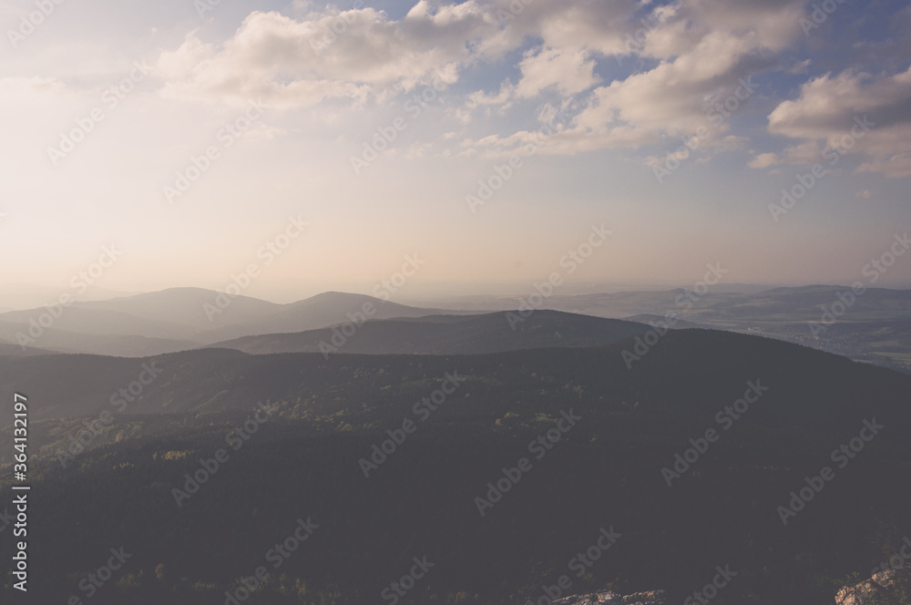 Late afternoon in the valley covered with fog under slightly cloudy sky and last rays of sun for the day Late afternoon in the valley covered with fog under slightly cloudy sky and last rays of sun for the day